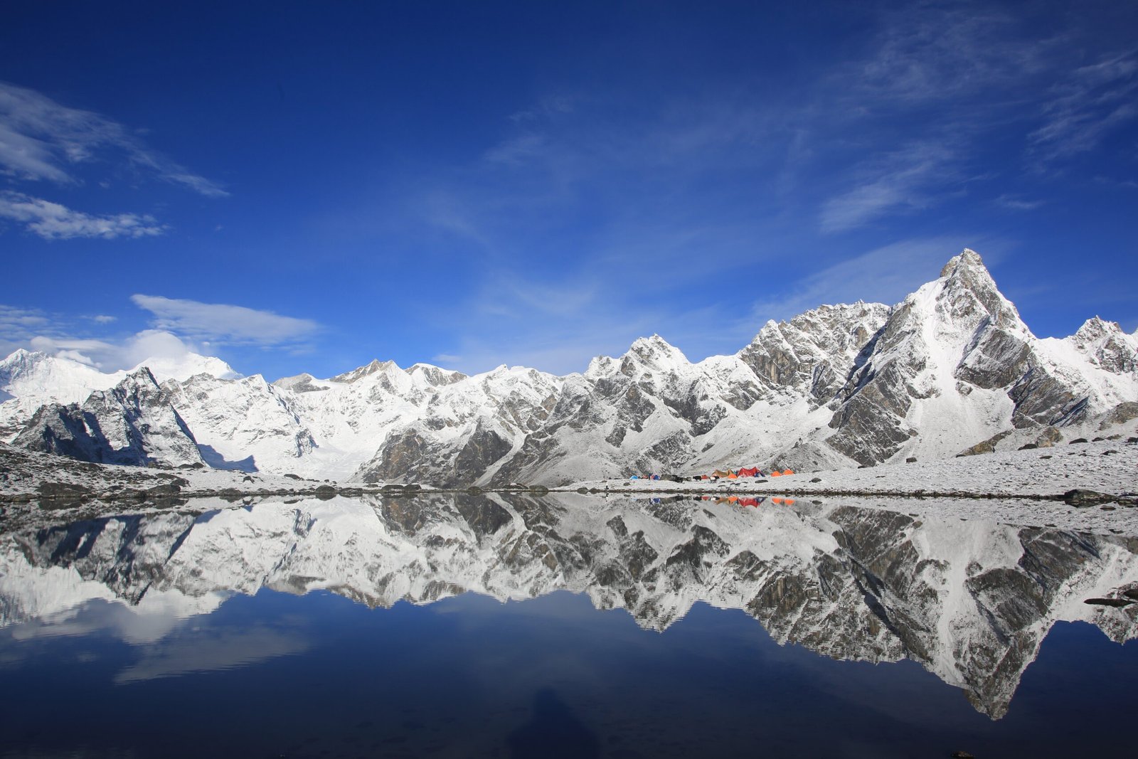 snow-covered mountain reflected in the water